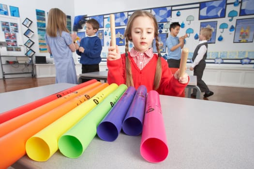 Group Of Primary Schoolchildren Having Music Lesson In Classroom