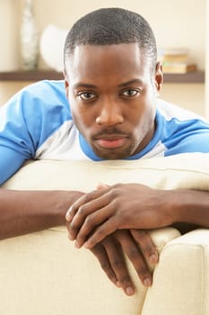 Man Relaxing On Sofa At Home