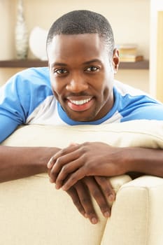 Man Relaxing On Sofa At Home