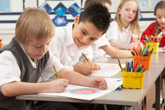 Group Of Primary Schoolchildren In Classroom Working At Desks