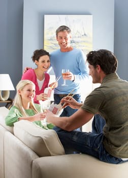 Group Of Friends Enjoying Chinese Takeaway Meal At Home