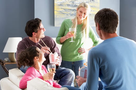 Group Of Friends Enjoying Chinese Takeaway Meal At Home