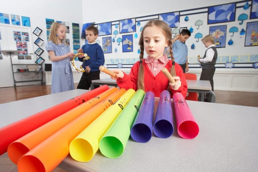 Group Of Primary Schoolchildren Having Music Lesson In Classroom
