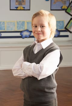 Portrait Of Male Primary School Pupil Standing In Classroom