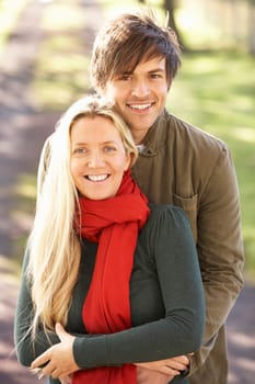 Portrait Of Romantic Young Couple In Autumn Park