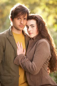 Portrait Of Romantic Young Couple In Autumn Landscape