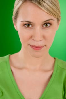 Portrait of young woman on green background