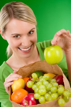 Healthy lifestyle - woman with fruit shopping paper bag