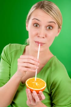 Healthy lifestyle - woman drink juice from orange