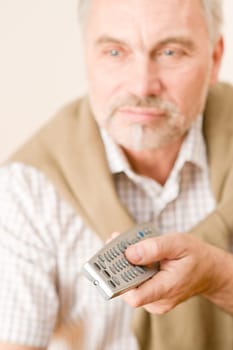 Senior mature man with remote control