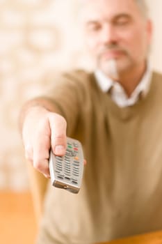 Senior mature man with remote control