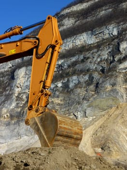 Orange mechanical digger arm