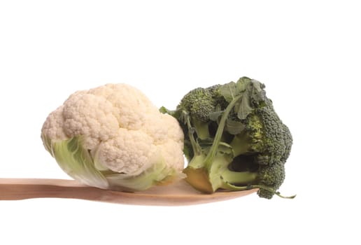 Broccol and a mini cauliflower on a wood