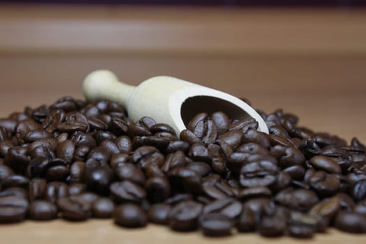 Espresso beans with wooden shovel