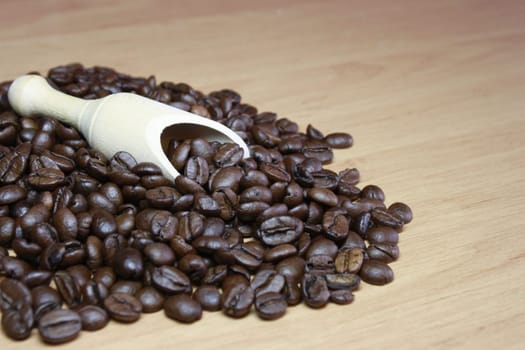 Espresso beans with wooden shovel