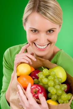Healthy lifestyle - woman with fruit shopping paper bag