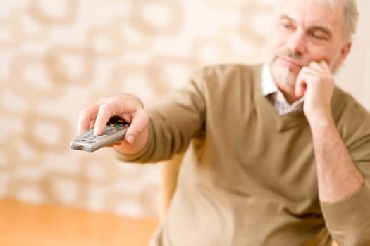 Senior mature man with remote control