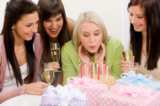 Birthday party - woman blowing candle on cake