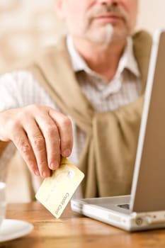 Senior mature man - home shopping with credit card