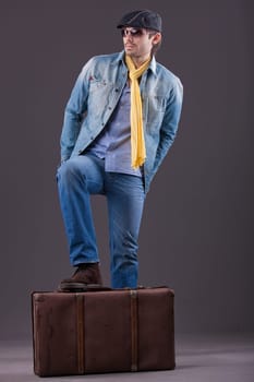 man in denim with suitcase