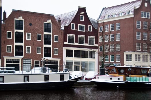 Amsterdam canal with house boats and gabled houses