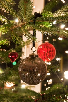 Various Christmas balls hanging from Christmas tee