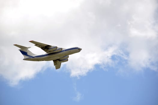 Cargo airplane (Russian make) with huge transport capacity taking off into a cloudy sky