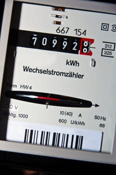 closeup on electricity usage meter with German text