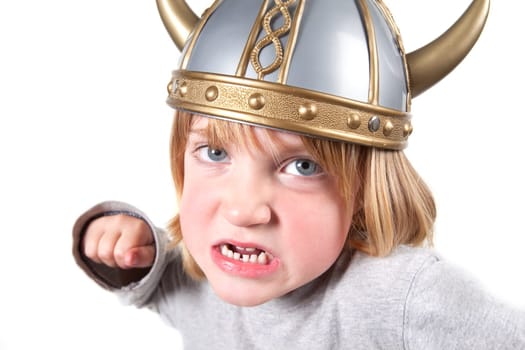 child with viking helmet isolated on white. kid aggressive attitude punch camera