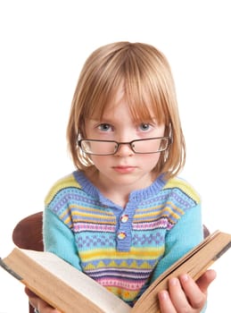 child with glasses reading a book isolated on white, small kid with literature or story