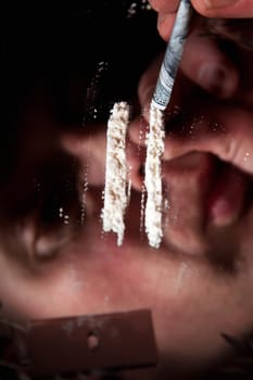 cocaine or other narcotic in line. addict with dollar bill for snorting illegal drugs