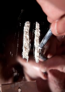 cocaine or other narcotic in line. addict with dollar bill for snorting illegal drugs
