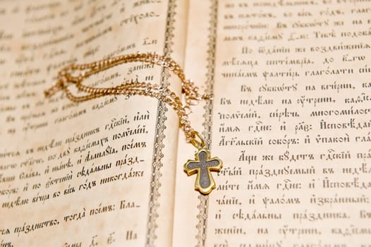 The cross lies on the orthodox bible