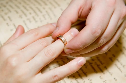 The man&#039 s hand dresses a ring on a female finger taken as close up