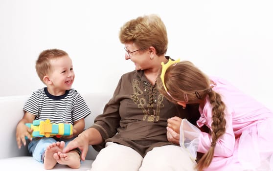 Cute little boy and little girl happy with grandmother