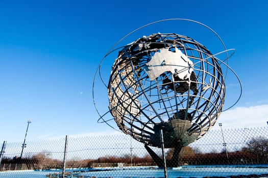 The Earth World Unisphere globe in Flushing Meadows Corona Park in Queens New York at a bright sunny day with blue skies.