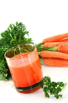 a glass of carrot juice with fresh ingredients