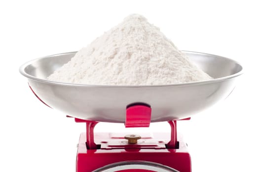 plain flour on red metal weighing scales