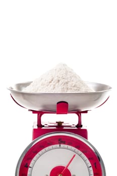 plain flour on red metal weighing scales