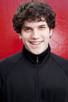 Portrait of young man smiling  with red background