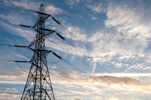 Low angle perspective shot of electric tower with at dusk.