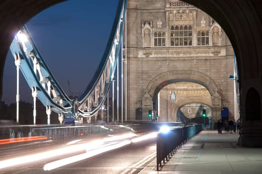 Detail of Tower Bridge in London at dusk with car light trail.