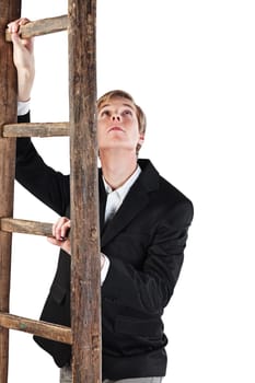 Young handsome blond man holds old wooden ladder and looks up