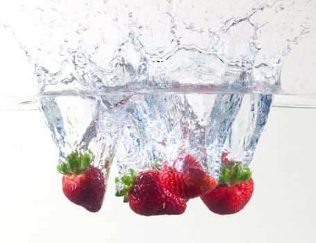 Ripe Strawberries Dropping Into Water