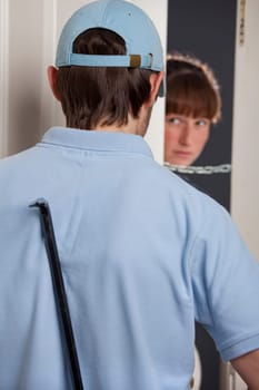 woman opening the door and seeing the thief with crowbar
