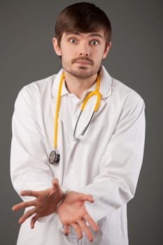 nothing can do - metaphor, doctor hands tied up over grey background