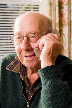 Senior man texting and calling with mobile phone