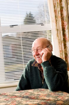 Senior man texting and calling with mobile phone