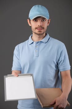 postman delivering a small package with clipboard for signature