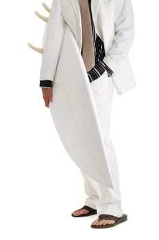 Man in white suit holding surfboard